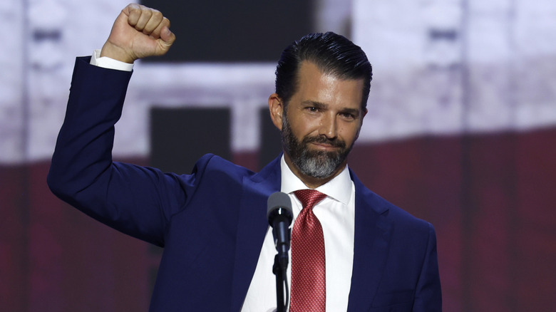 Donald Trump Jr. at podium raising fist