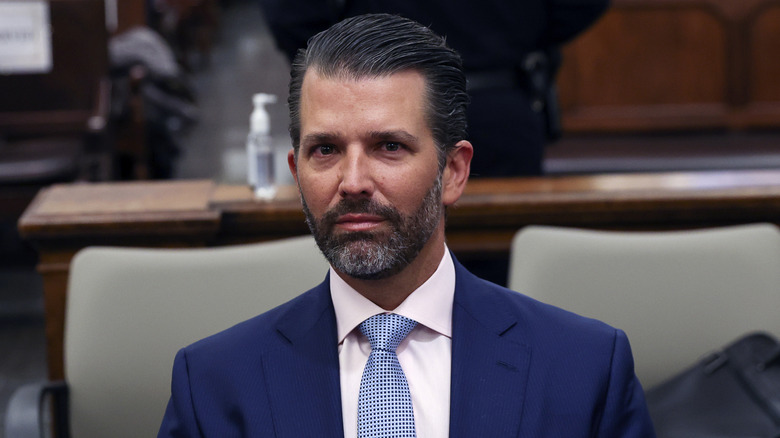 Donald Trump Jr. looking worried in a suit