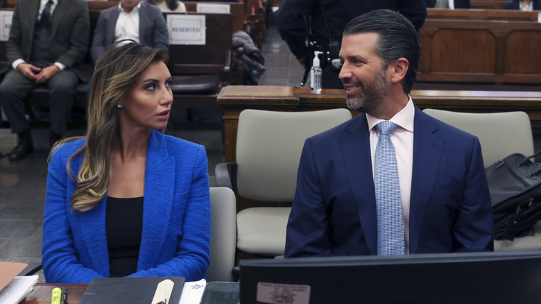 Donald Trump Jr. and Alina Habba sitting next to each other in a courtroom