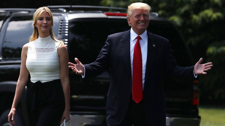 Ivanka Trump smiling slightly and Donald Trump holding out his hands
