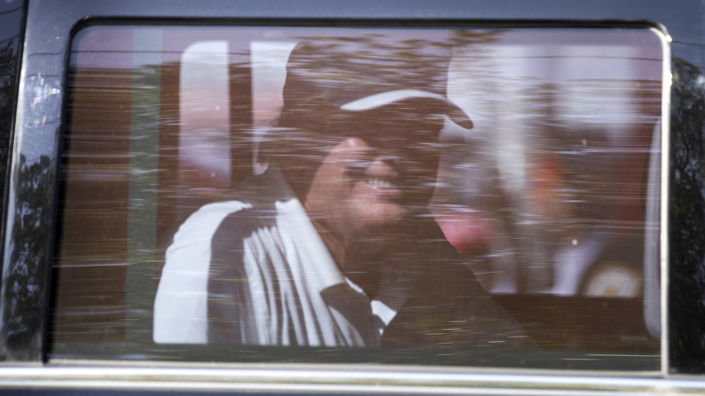 Donald Trump smiling inside car