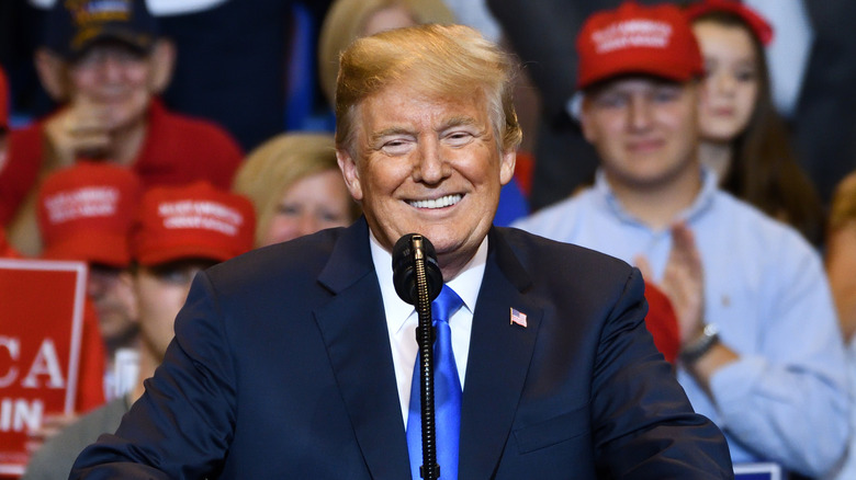 Donald Trump smiling at a podium