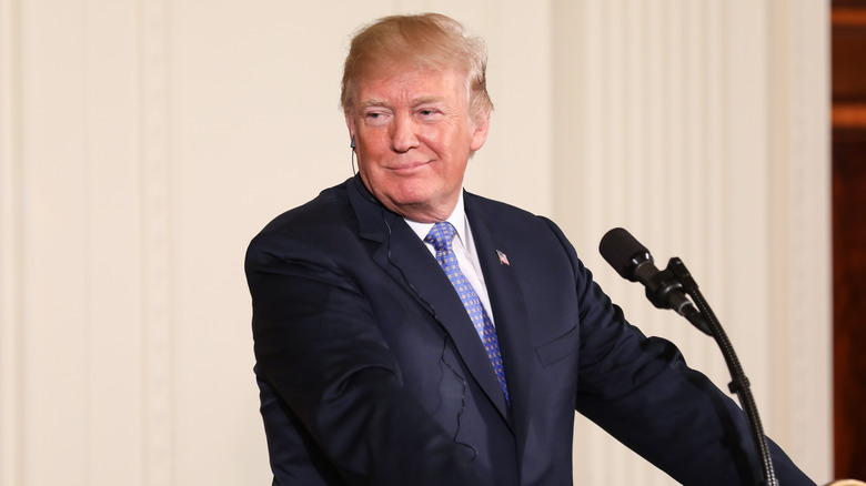 Donald Trump standing at a podium at the White House