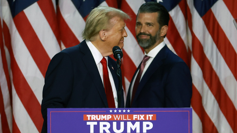 Donald Trump and Donald Trump Jr. on stage at a convention.