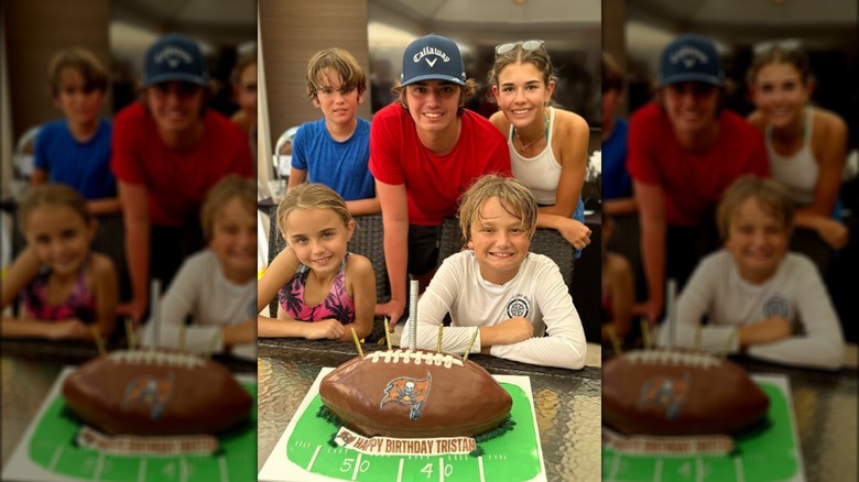 Tristan Trump posing in front of birthday cake