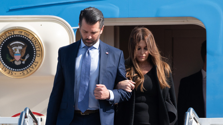 Donald Trump Jr. and Kimberly Guilfoyle exiting plane