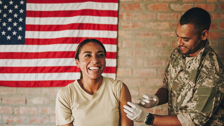 Service personnel being vaccinated by military nurse