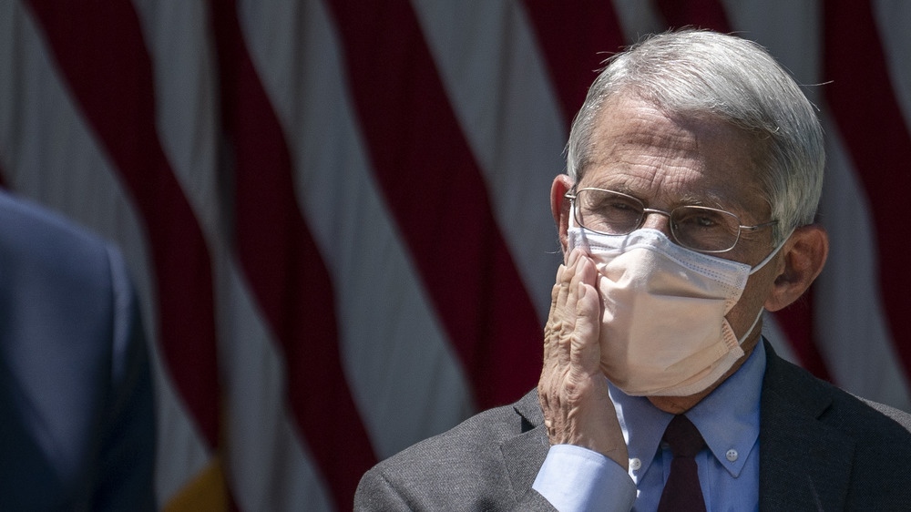 Anthony Fauci listening to Donald Trump speak