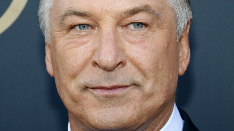 Alec Baldwin with a slight smile