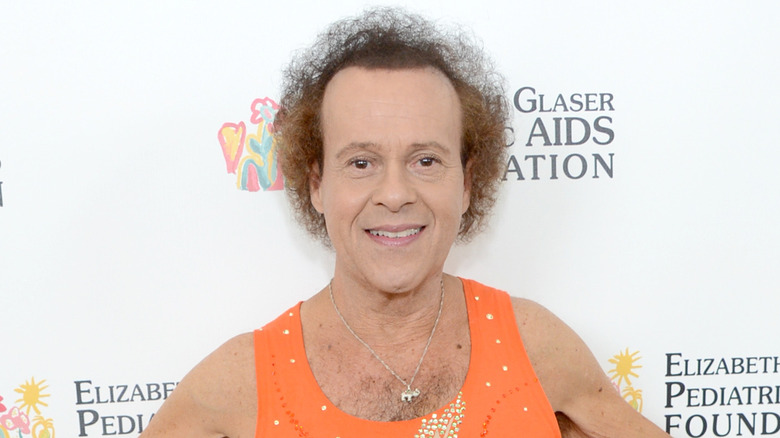 Richard Simmons smiling at a red carpet event