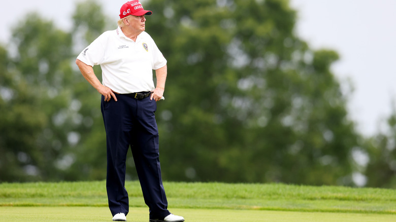 Donald Trump stands on golf course