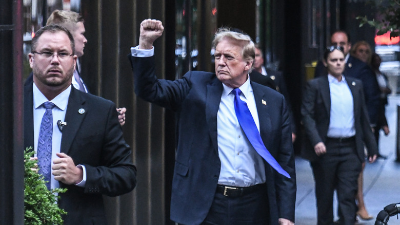 Donald Trump raises fist outside courtroom