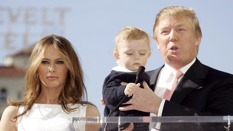 Melania, Donald and baby Barron Trump at microphone