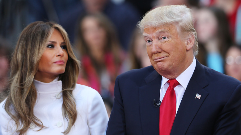 Donald Trump shrugs next to wife Melania Trump