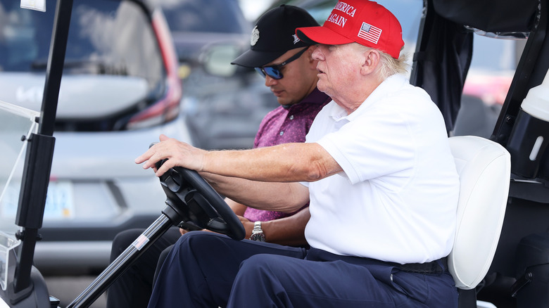 Donald Trump driving a golf cart