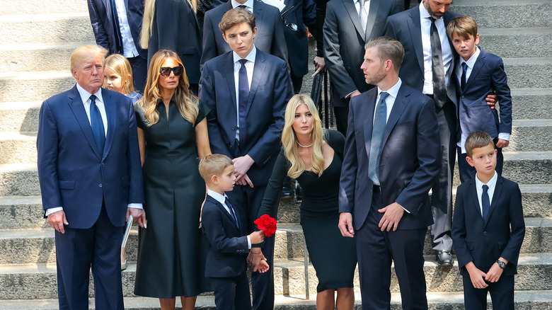 The Trump family standing on steps