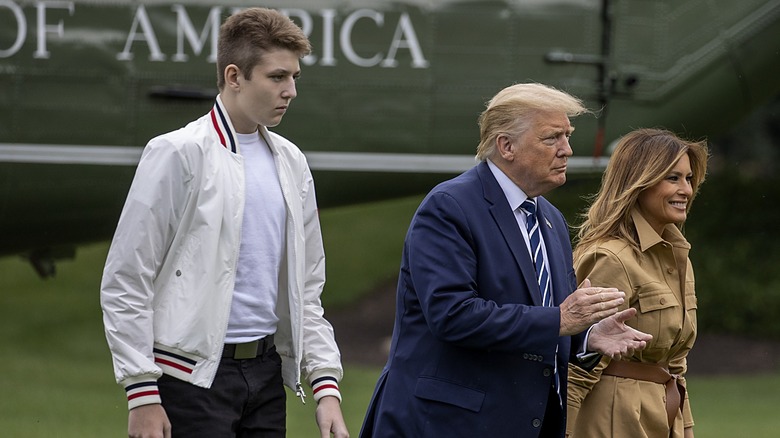 Barron Trump walking with his parents