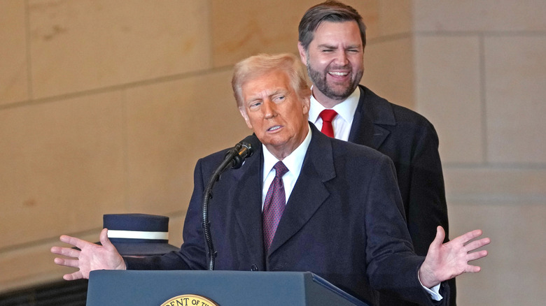 Donald Trump talking while JD Vance laughs