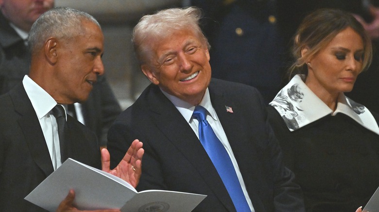 Barack Obama and Donald Trump talking at Carter funeral