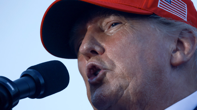 Closeup of Donald Trump speaking into a microphone