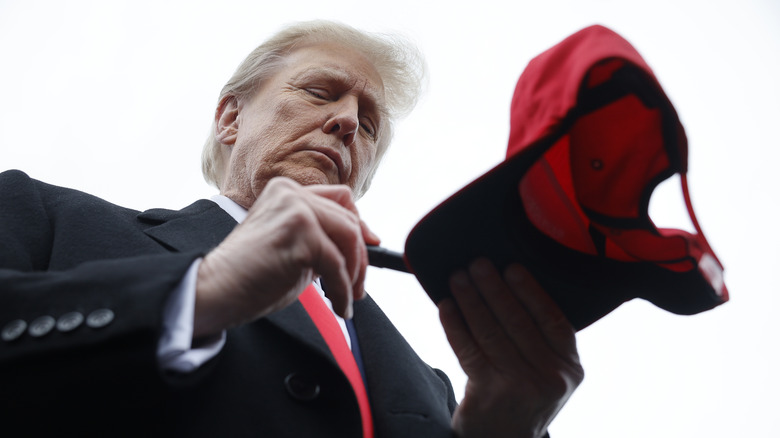 Donald Trump signing a hat