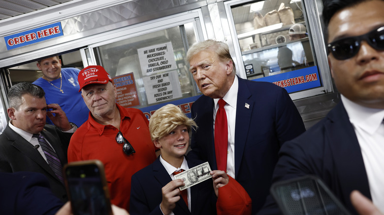 Donald Trump posing with a young fan