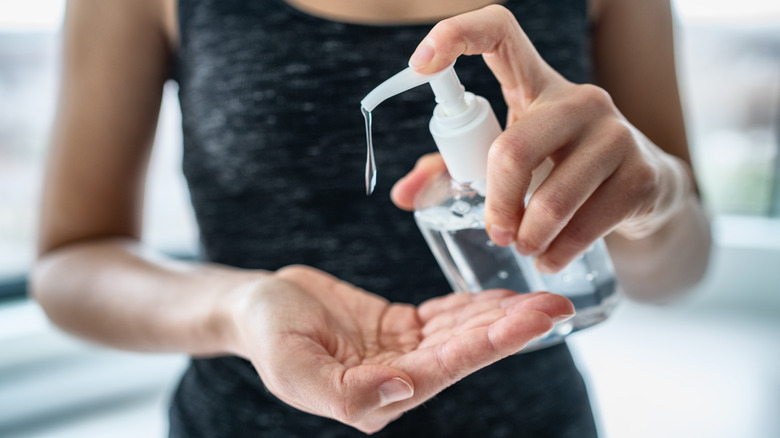 woman dispending soap into her hand