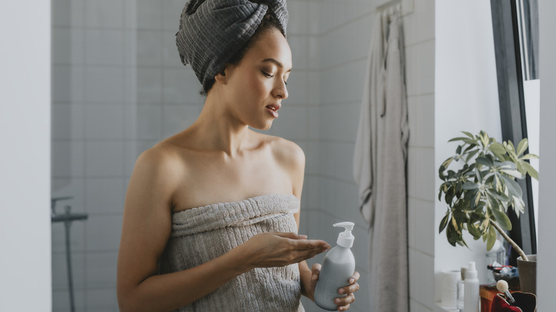 Worried woman looking at moisturizer