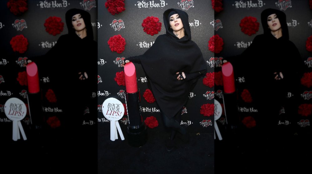 Kat Von D with a Kat Von D Beauty display