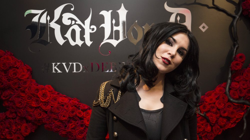 Kat Von D with a Kat Von D Beauty display