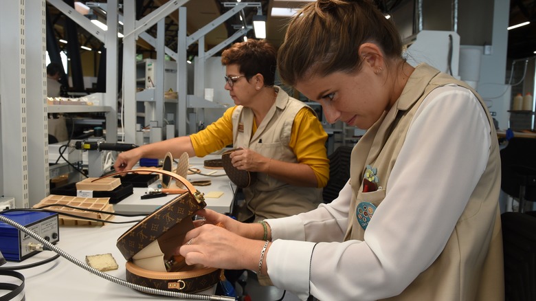 Employee working with Louis Vuitton bag