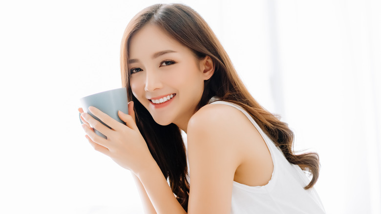 Woman smiling with cup of coffee