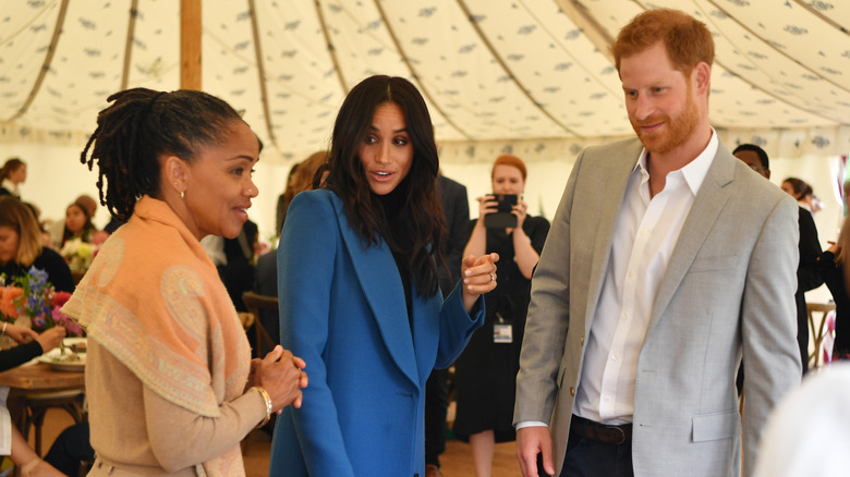 Prince Harry, Meghan Markle and Doria Ragland at an event