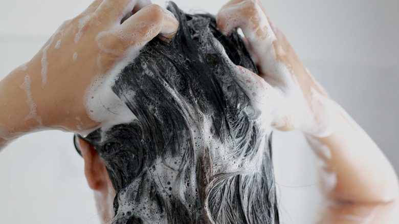 Woman using clarifying shampoo 