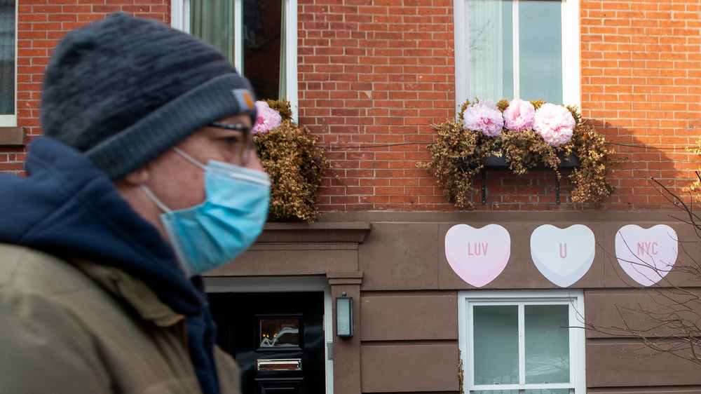 Man walking outside wearing a mask