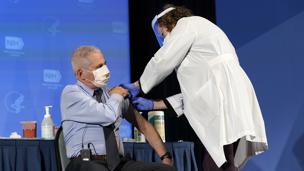 Masked Dr. Fauci getting vaccinated