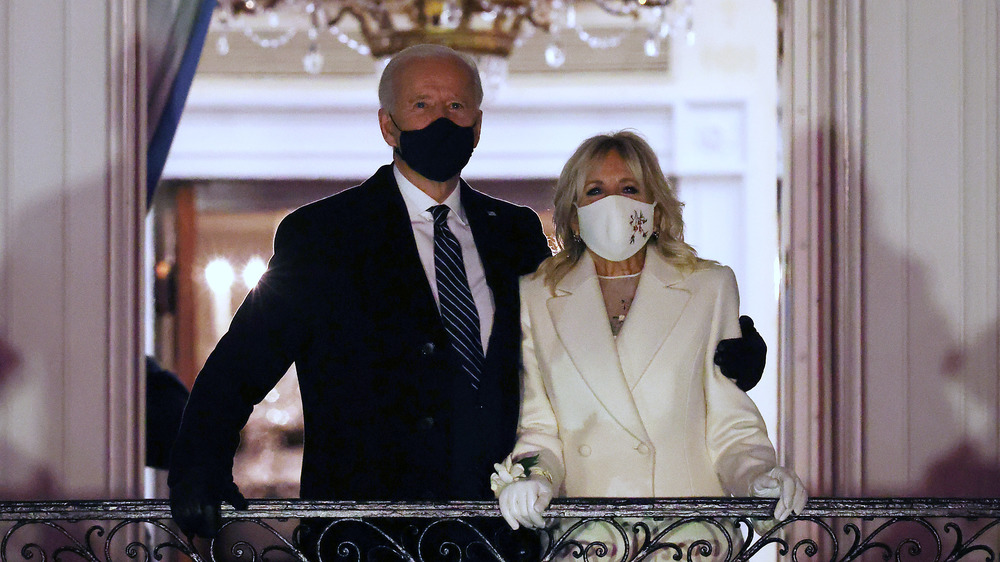 Jill Biden, Joe Biden on White House balcony, wearing masks