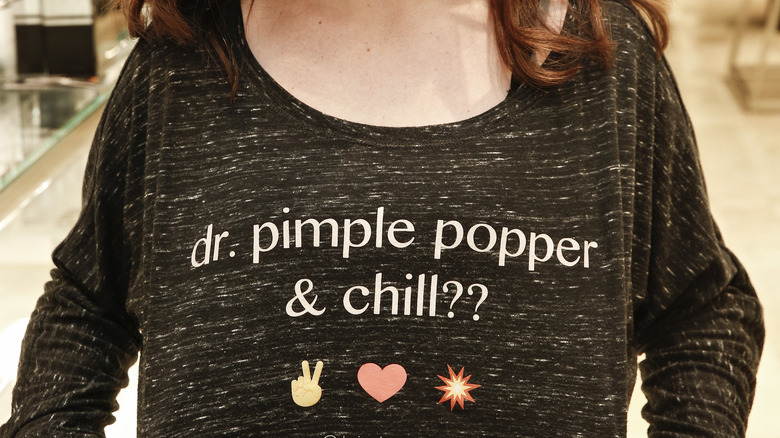 Woman wearing a "Dr. Pimple Popper & Chill" t-shirt