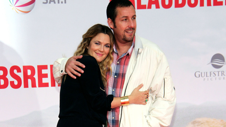 Drew Barrymore and Adam Sandler hugging