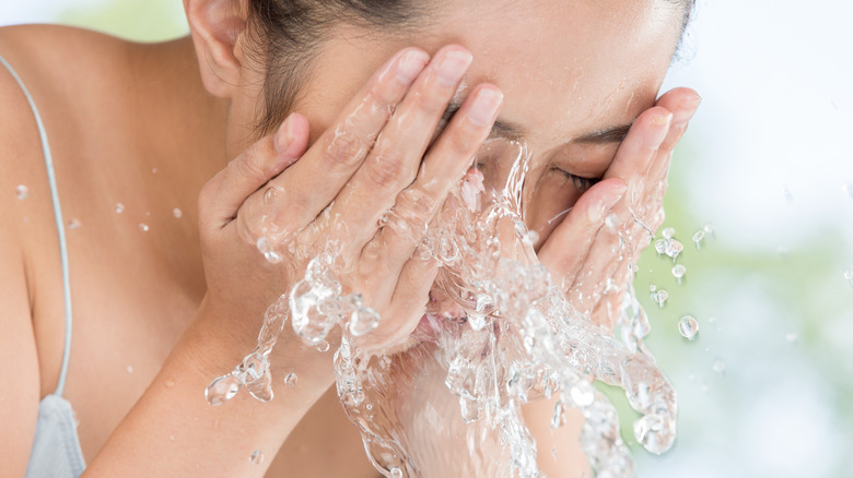 Woman washing her face