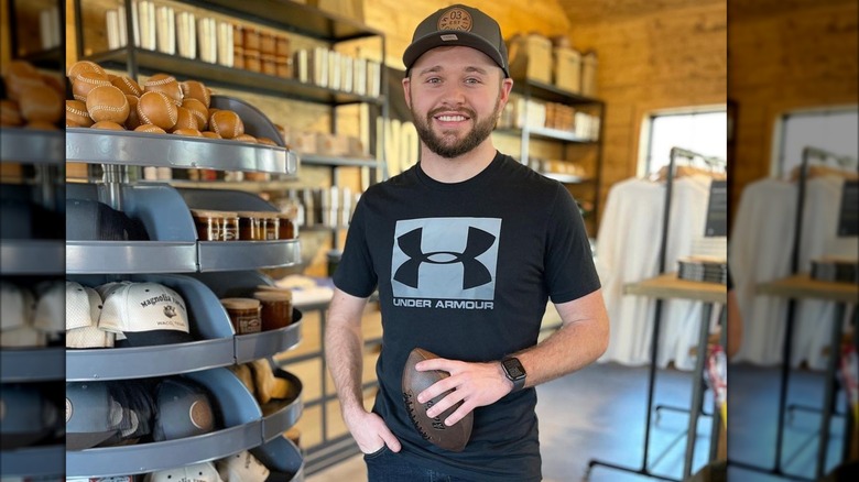 Jason Duggar in Under Armour shirt holding football