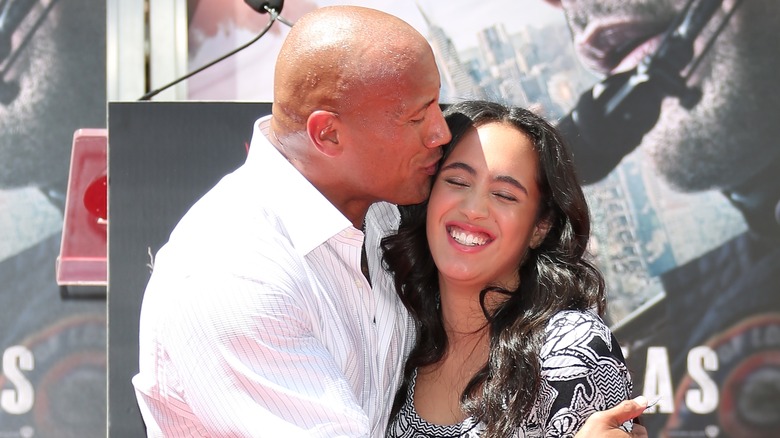 Dwayne Johnson kissing Simone Johnson on the forehead