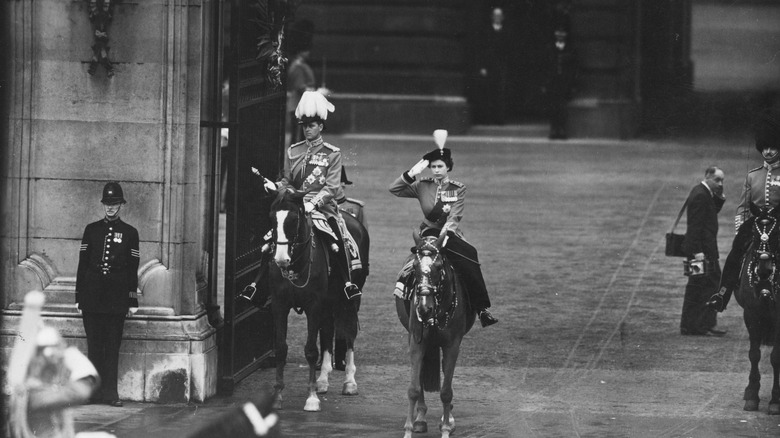 Young Queen Elizabeth II saluting on horse