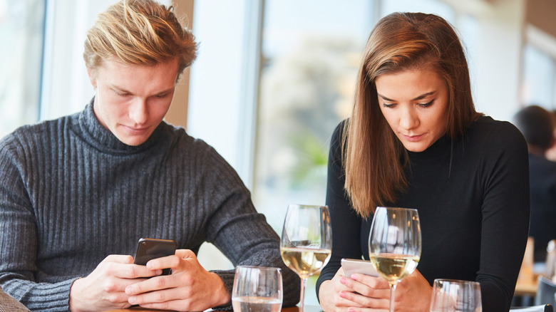 couple on their phones at dinner, huge turn-offs