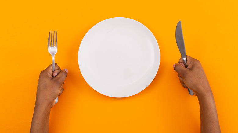 person holding fork and knife in fists, a huge turn-off