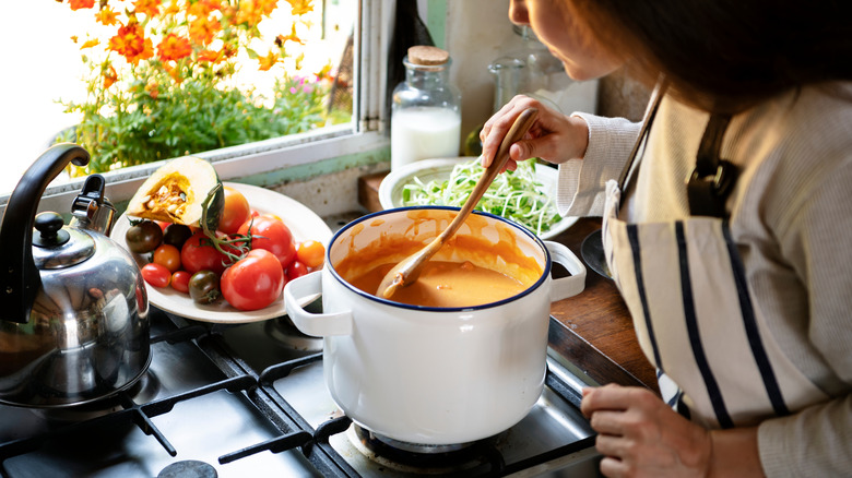 Woman making pumpkin soup
