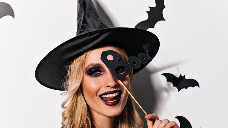 Woman posing in a witch costume