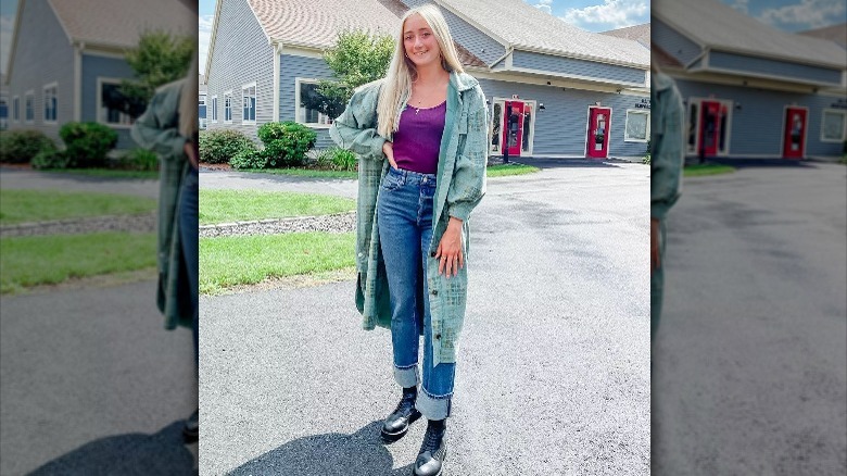 Woman wearing cuffed straight leg jeans and ankle boots