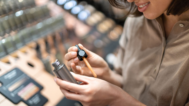 woman testing concealer at the store