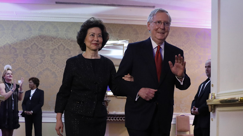 Elaine Chao walking with Mitch McConnell